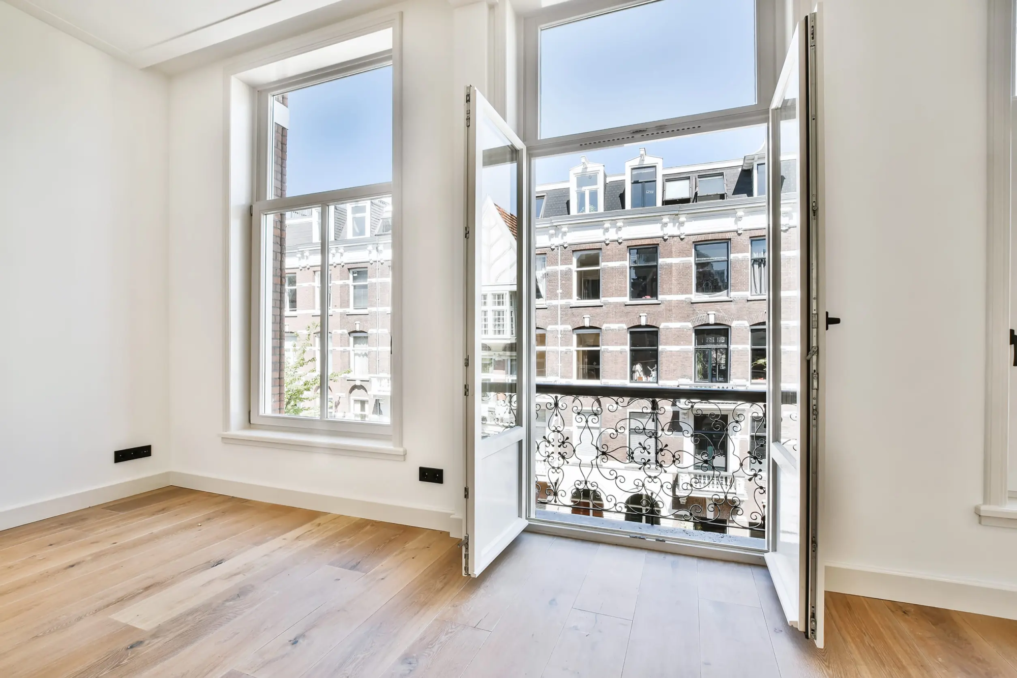 Luxury white aluminium Windows and doors shot from the inside out of a modern home balcony